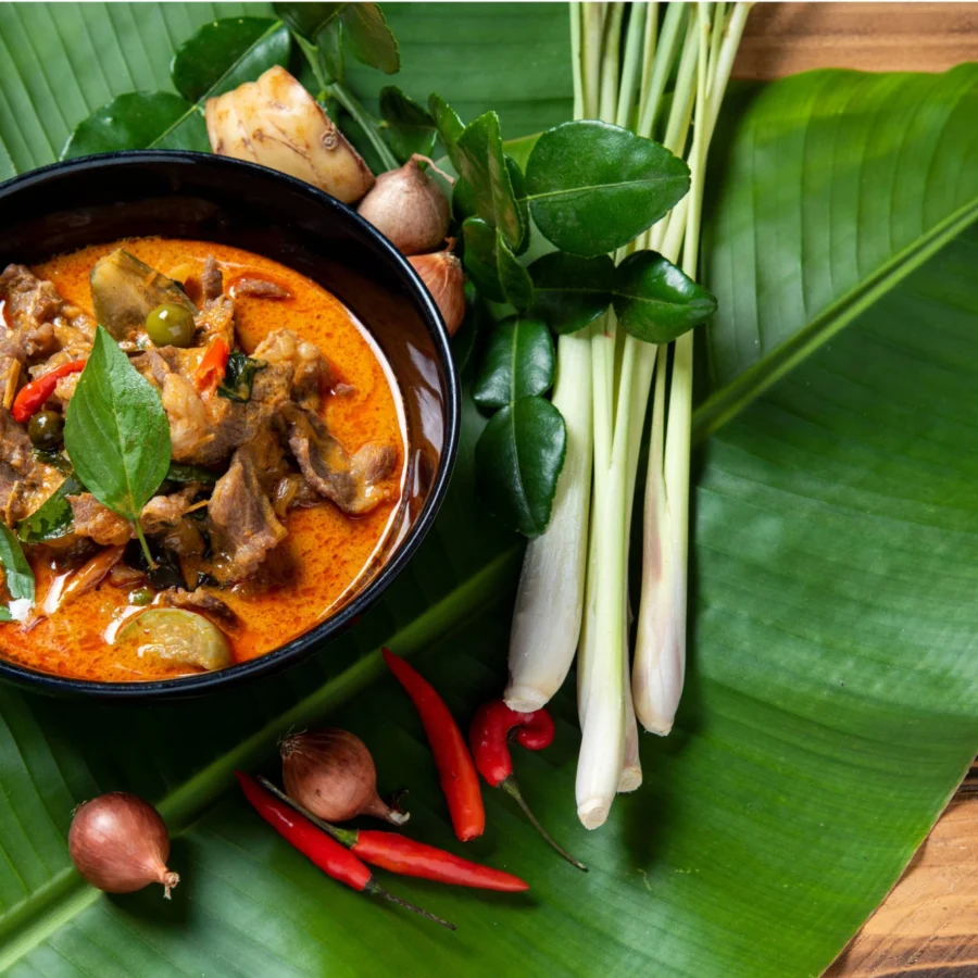 Thai red curry served on a bamboo leaf.